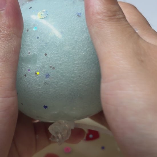 Frosty light‑blue handmade squishy ball with holographic star and dot sequins. Soft light‑force icy‑sand texture, calming ASMR crunch sound, viral aesthetic stress fidget toy.
