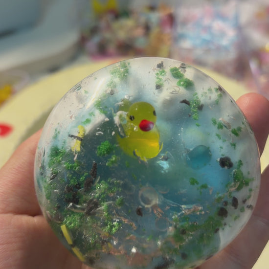 Gradient lake‑blue handmade crispy squishy with a tiny yellow duck, grass and stone decorations. Medium squeeze creates addictive crunchy ASMR noise, viral aesthetic stress fidget toy.