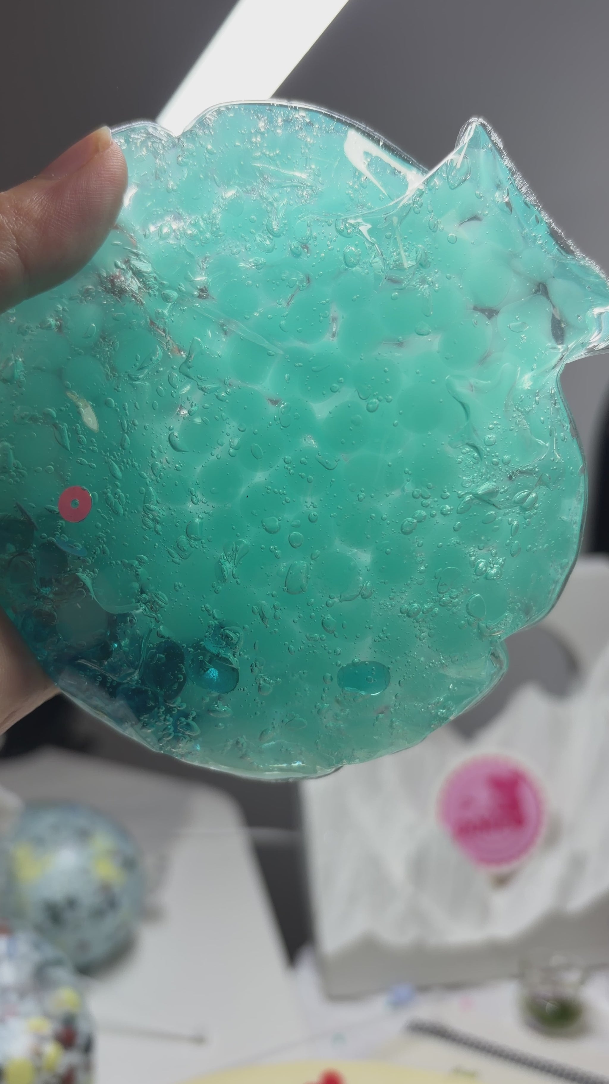 Handmade transparent mint‑blue squishy pouch. Light‑blue beads can be crushed with medium squeeze. Enjoy satisfying popping ASMR sounds, viral stress relief fidget toy.